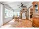 Bright sunroom features terra cotta tile flooring, brick accent wall, and large windows offering serene views at 2244 Deer Ridge Dr, Tucker, GA 30087