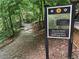 Informative sign for the Smoke Rise Community Walking Trail, set amid lush greenery at 2244 Deer Ridge Dr, Tucker, GA 30087