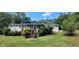 Spacious backyard featuring a well-maintained lawn, screened porch, and lush, mature trees for privacy at 294 A Donald Rd, Canton, GA 30114