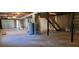 Unfinished basement with a garage door, water heater, wooden stairs, and concrete flooring at 294 A Donald Rd, Canton, GA 30114