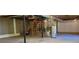 Open basement with support beams, water heater, unfinished walls, and wooden stairs at 294 A Donald Rd, Canton, GA 30114