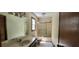Well-lit bathroom featuring tile floors, ample vanity space, and a shower-tub combination at 294 A Donald Rd, Canton, GA 30114