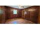 This bedroom is paneled with wood, features wood floors, a window and a closet at 294 A Donald Rd, Canton, GA 30114