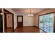 Dining room with hardwood floors, chandelier, wood door and sliding door to the screen porch at 294 A Donald Rd, Canton, GA 30114
