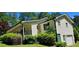 Exterior of house with long covered porch, driveway, and wooded lot at 294 A Donald Rd, Canton, GA 30114
