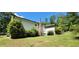 Exterior of house featuring chimney, screened in porch and green yard at 294 A Donald Rd, Canton, GA 30114