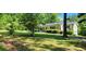 Single-story home with wooded views, landscaped yard, and driveway at 294 A Donald Rd, Canton, GA 30114