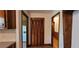 View of the kitchen, a closet and hallway with hardwood floors, and wooden trim at 294 A Donald Rd, Canton, GA 30114