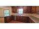 Kitchen with stainless steel appliances and gray countertops with backsplash, wooden cabinets and hardwood floors at 294 A Donald Rd, Canton, GA 30114