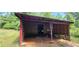 A rustic outbuilding with a wood frame is ideal for storage or a workshop in a wooded area at 294 A Donald Rd, Canton, GA 30114