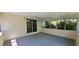 Screened in porch with gray wood flooring, windows, and ceiling fan at 294 A Donald Rd, Canton, GA 30114