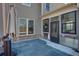 Backyard patio with outdoor umbrella, grill, and door to screened-in outdoor living area at 5015 Montes Ln, Cumming, GA 30040