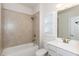 Bright bathroom featuring a shower-tub combo, undermount sink, and white vanity at 5015 Montes Ln, Cumming, GA 30040