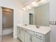 Bathroom vanity featuring dual undermount sinks, large mirror and updated fixtures at 5015 Montes Ln, Cumming, GA 30040