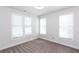 Comfortable bedroom with plush carpet and bright windows at 5015 Montes Ln, Cumming, GA 30040