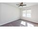 Well lit bedroom with neutral carpet, ceiling fan, and dual windows at 5015 Montes Ln, Cumming, GA 30040