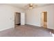 Spacious bedroom with neutral carpet, ensuite bath, walk-in closet, and ample natural light from windows at 5015 Montes Ln, Cumming, GA 30040