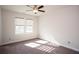 Bright bedroom featuring neutral carpet, ceiling fan, and dual windows at 5015 Montes Ln, Cumming, GA 30040