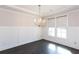 Dining room features hardwood floors, large windows with shades, and chandelier at 5015 Montes Ln, Cumming, GA 30040