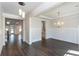 Bright dining room features elegant lighting fixtures, wood floors, and detailed trim work at 5015 Montes Ln, Cumming, GA 30040