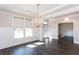 Beautiful dining room with hardwood floors, large window, and elegant chandelier at 5015 Montes Ln, Cumming, GA 30040
