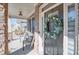 Charming front door with a wreath, complemented by the welcoming front porch and decorative stone pillars at 5015 Montes Ln, Cumming, GA 30040