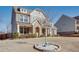 Two-story home featuring brick and stone accents, a manicured lawn, and a welcoming front porch at 5015 Montes Ln, Cumming, GA 30040