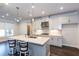 Gourmet kitchen featuring granite countertops, stainless steel appliances, and pendant lighting at 5015 Montes Ln, Cumming, GA 30040