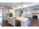 Modern kitchen with stainless steel appliances, granite countertop, and open floor plan at 5015 Montes Ln, Cumming, GA 30040