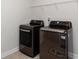 Laundry room showcasing modern washer and dryer set under wire shelving at 5015 Montes Ln, Cumming, GA 30040