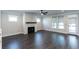 Large living room featuring hardwood floors, fireplace, and bright windows with shades at 5015 Montes Ln, Cumming, GA 30040