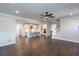 Open-concept living area with hardwood floors, modern kitchen, and staircase at 5015 Montes Ln, Cumming, GA 30040