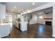 Open concept living space featuring a modern kitchen, fireplace, and hardwood floors at 5015 Montes Ln, Cumming, GA 30040