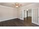 Bright living room featuring hardwood floors, ceiling fan, and glass doors to additional space at 5015 Montes Ln, Cumming, GA 30040