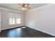 Office featuring wood floors, a ceiling fan, and ample natural light from large windows at 5015 Montes Ln, Cumming, GA 30040