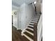 Bright staircase features wood treads, white risers, and a dark wood handrail for a classic design at 5015 Montes Ln, Cumming, GA 30040