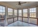 Bright sunroom with tile floors, ceiling fan, and multiple glass windows at 5015 Montes Ln, Cumming, GA 30040