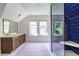 Contemporary bathroom with blue tiled shower and large vanity at 588 Oakdale Ne Rd, Atlanta, GA 30307