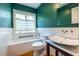 Updated bathroom with dark teal walls, white tile, modern fixtures and natural light at 588 Oakdale Ne Rd, Atlanta, GA 30307
