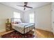 Bedroom featuring a metal bed frame, hardwood floors, colorful rug and two windows at 588 Oakdale Ne Rd, Atlanta, GA 30307