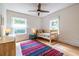 Bright bedroom with hardwood floors, a ceiling fan, windows, and neutral-toned walls at 588 Oakdale Ne Rd, Atlanta, GA 30307
