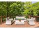 Charming outdoor deck with stylish wicker furniture surrounded by lush greenery at 588 Oakdale Ne Rd, Atlanta, GA 30307