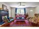 Bright living room with hardwood floors, fireplace, and large windows with blue curtains at 588 Oakdale Ne Rd, Atlanta, GA 30307