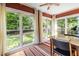 Bright sunroom with large windows providing a view of the landscaped backyard at 588 Oakdale Ne Rd, Atlanta, GA 30307