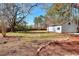 Expansive backyard featuring mature trees and a detached one car garage at 6316 Rockland Rd, Lithonia, GA 30038