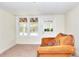 Finished basement area featuring a cozy sofa, carpet, and access to the outdoors at 6316 Rockland Rd, Lithonia, GA 30038