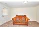 Finished basement space with a comfortable sofa and natural light from exterior access at 6316 Rockland Rd, Lithonia, GA 30038