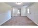 Finished basement with carpet, neutral paint, access to other rooms, and an exit door at 6316 Rockland Rd, Lithonia, GA 30038
