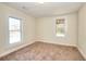 Bright bedroom with carpet flooring and two windows offering natural light at 6316 Rockland Rd, Lithonia, GA 30038