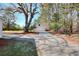 Long driveway leading up to detached garage in wooded area at 6316 Rockland Rd, Lithonia, GA 30038